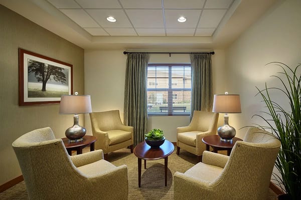 Cozy lounge with chairs, table, and window