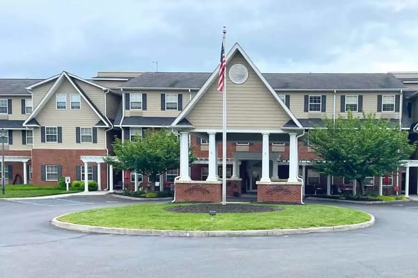 Entrance with American flag and landscaped area at TerraBella Pheasant Ridge