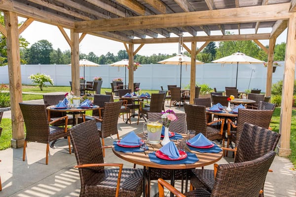 Tables set for dining in the outdoor area with umbrellas
