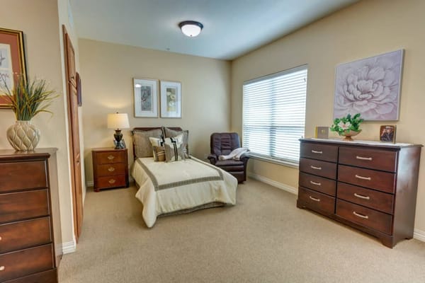 Cozy private resident room with a bed and dresser
