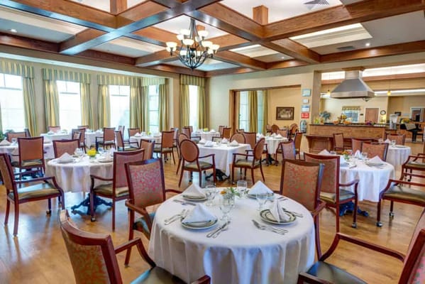 Dining room with elegantly set tables and chairs