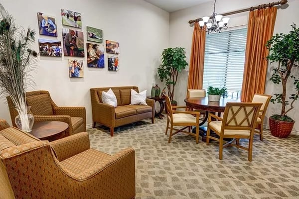 Comfortable seating area with plants and artwork