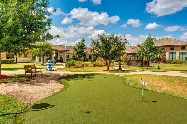 Well-maintained outdoor space with putting green and seating