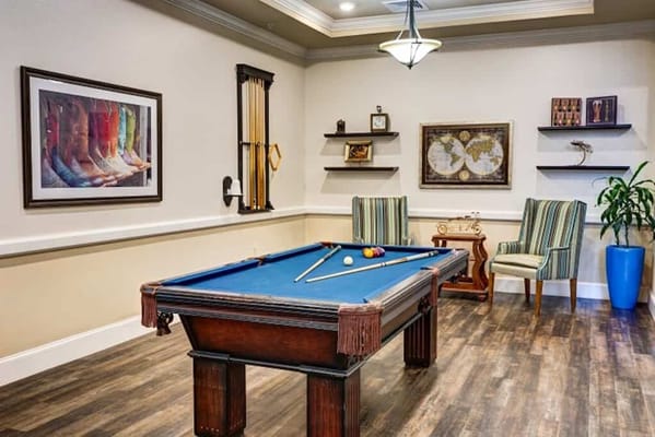 Interior game room with pool table and seating