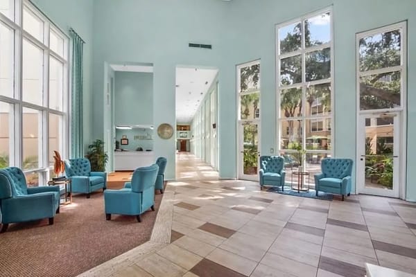 Bright and inviting common area with teal chairs