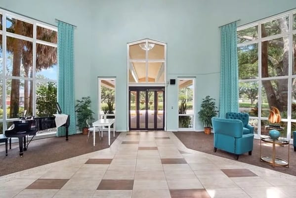 Bright interior lobby with piano and seating