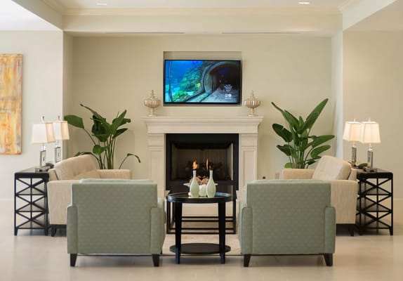 Comfortable seating area in the lobby with a fireplace and TV