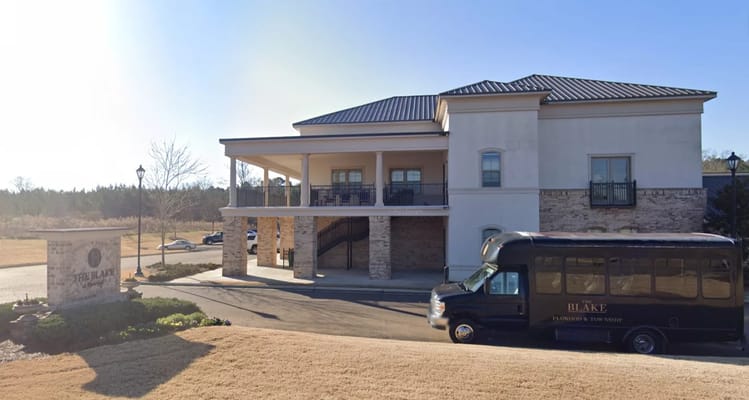 Exterior of The Blake at Flowood with a shuttle bus in front