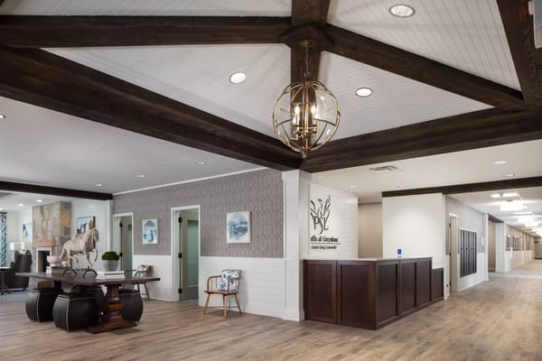 Spacious lobby with wood beams and reception desk