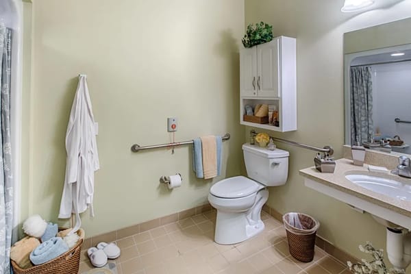 Clean bathroom with safety features and amenities
