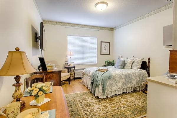 Cozy resident room with floral decor and amenities
