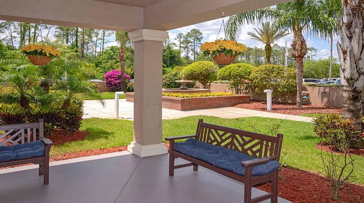 View of a porch with seating overlooking a garden