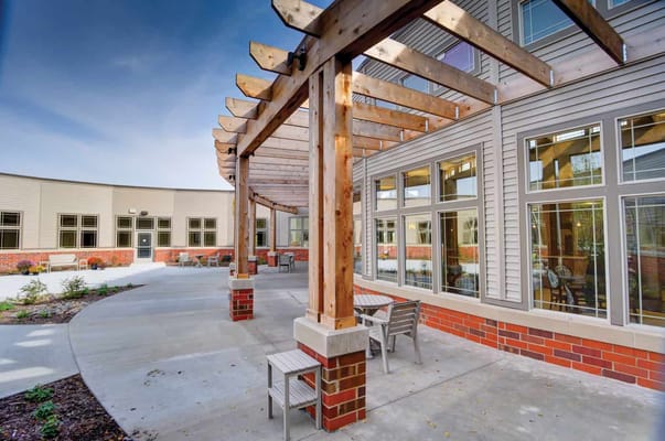 Outdoor courtyard with wooden trellis and seating