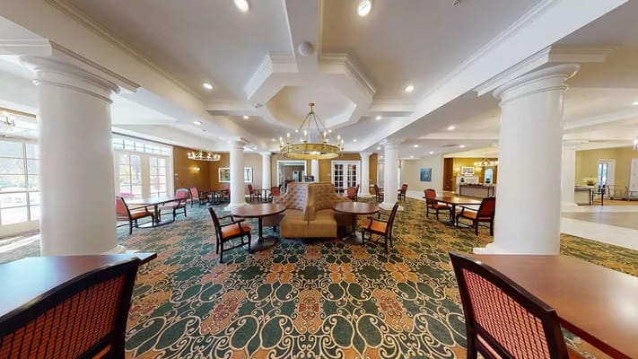 Spacious lobby area with seating and tables