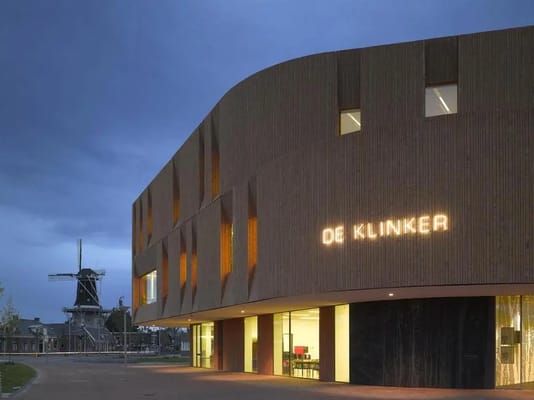 Exterior view of The Care Facility Klinker building with illuminated signage