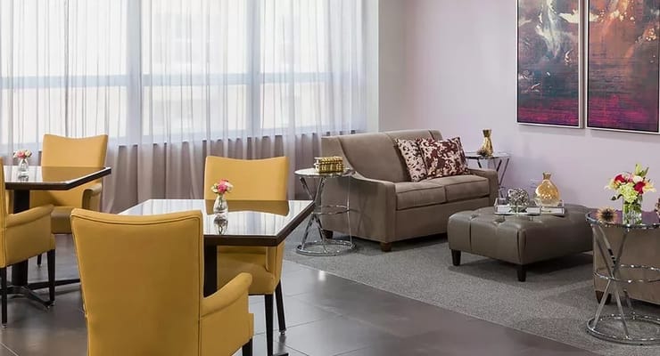 Bright living area with yellow chairs and a sofa