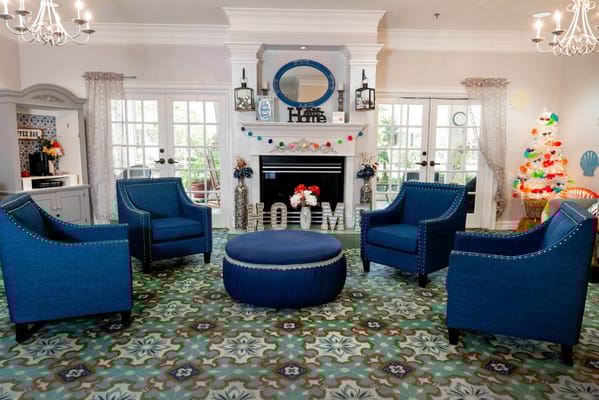 Cozy living room with blue chairs and a fireplace