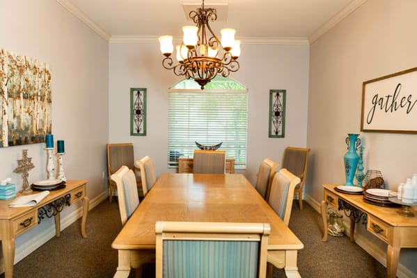 Spacious dining room with a chandelier and wooden table