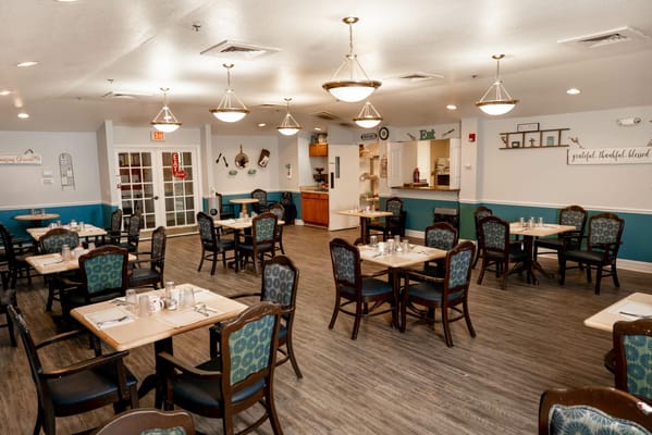 Spacious dining room with wooden tables and chairs