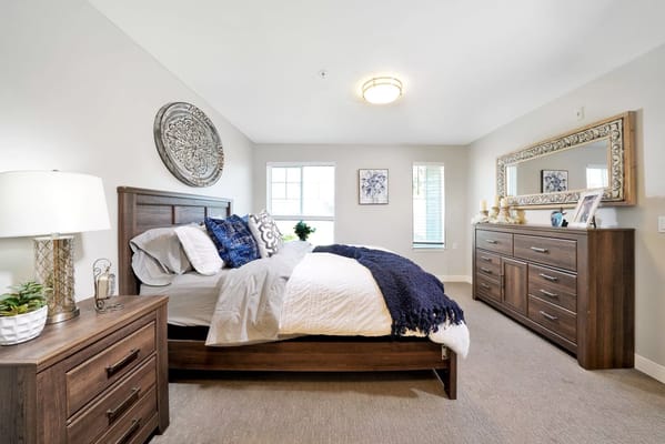 Brightly decorated bedroom with a bed, dresser, and bedside lamp