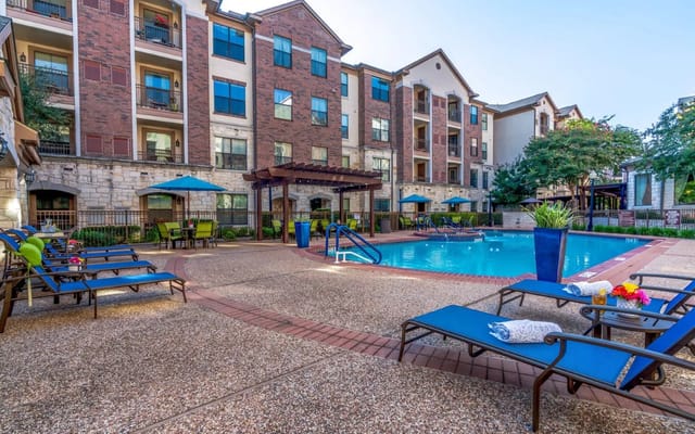 Outdoor pool area with lounge chairs and umbrellas