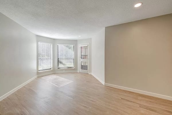 Bright living room with large windows and wooden flooring