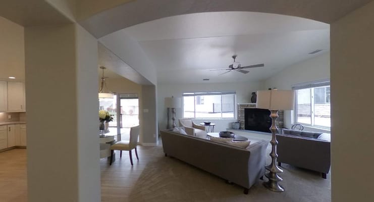 Bright living room with comfortable sofas and a dining area.