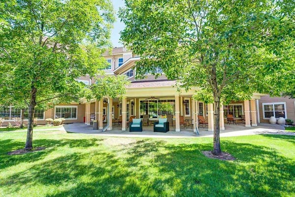 Outdoor seating under trees at The Courtyards at Mountain View