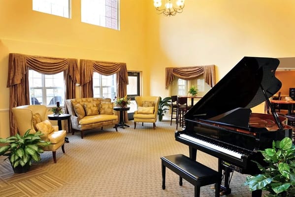Piano in a bright, inviting lobby with seating and plants