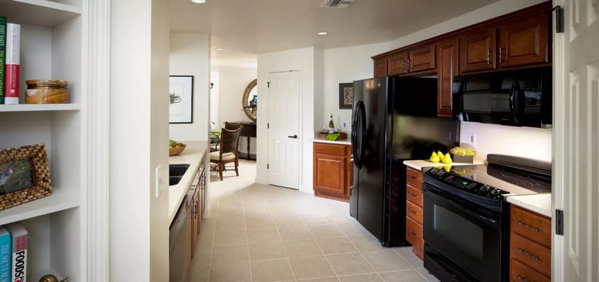 Bright kitchen area with cabinets and appliances