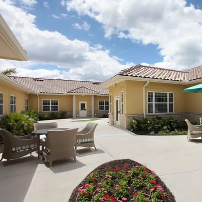 Sunny courtyard featuring seating and landscaping at The Fairways at Naples.