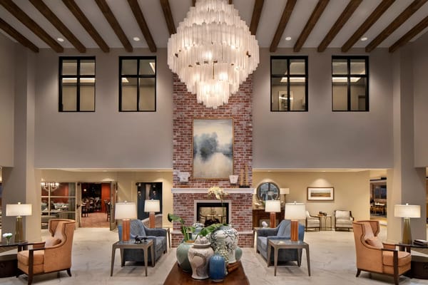 Modern interior lobby with ample seating and chandelier