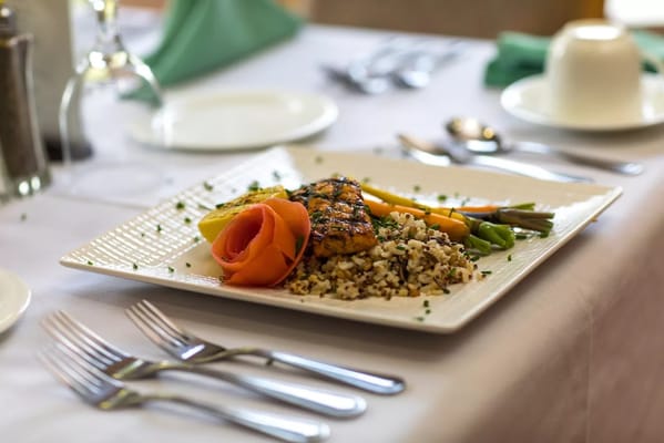 A beautifully plated meal with salmon and vegetables