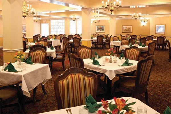 Spacious dining room with tables set for meals