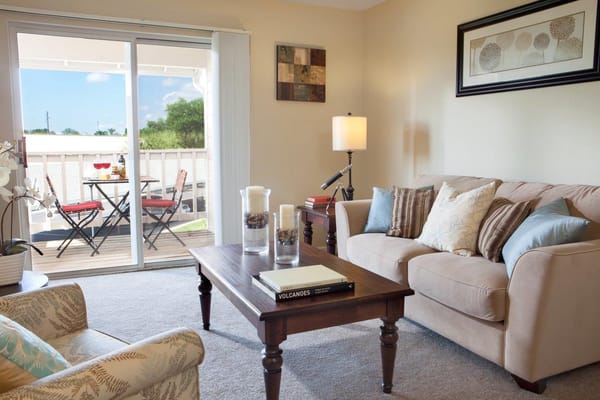 Bright living room with a view of the balcony and dining table