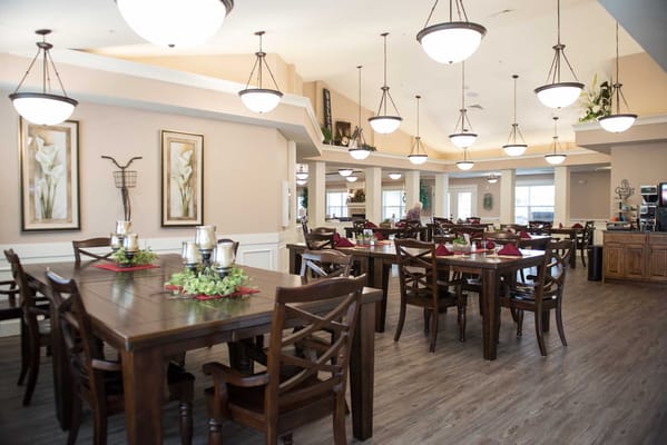 Dining area with wooden tables and floral centerpieces