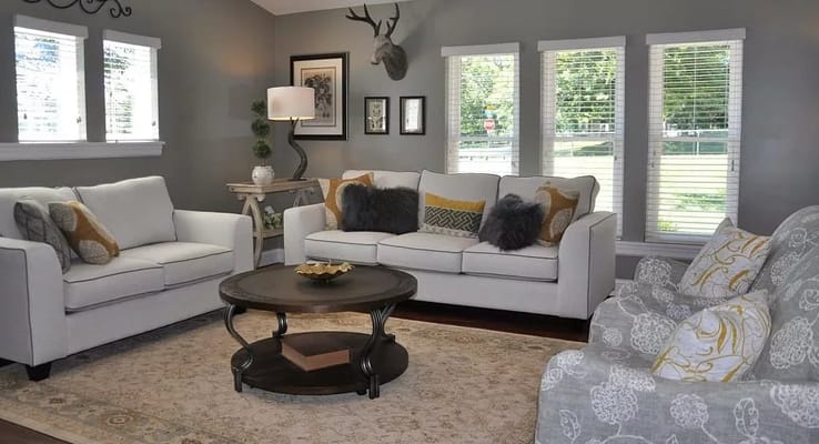 Comfortable living room with white sofas and decorative pillows