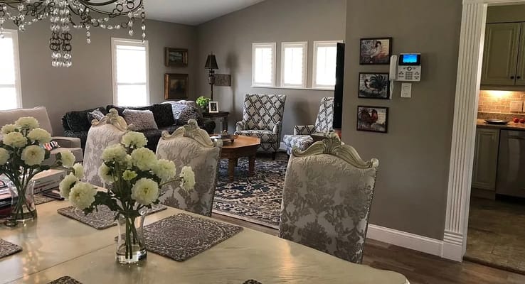 Cozy living room and dining area with floral centerpiece and comfortable seating