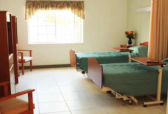 A comfortable resident room with two beds and a window