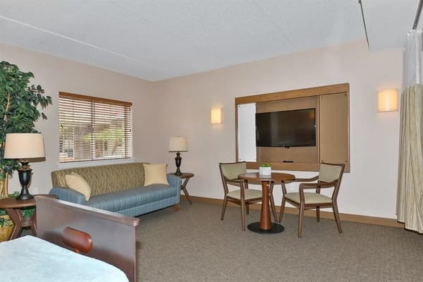 Comfortable living area with sofa, table, and TV