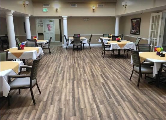 Spacious dining area with tables set for meals