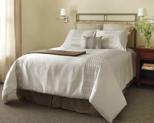 Comfortable bedroom with a double bed and bedside table.