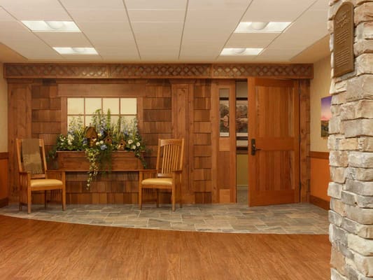 Wooden entrance lobby with seating and floral decorations