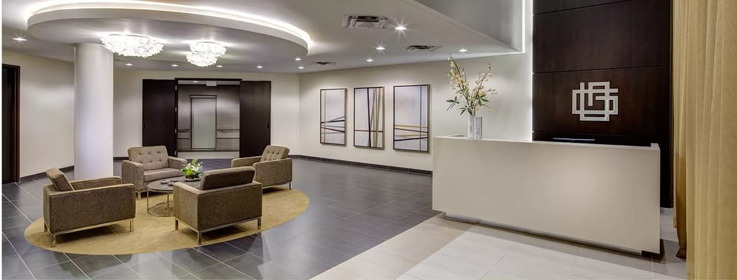 Modern lobby with seating and reception area at The Grove Fox Valley.