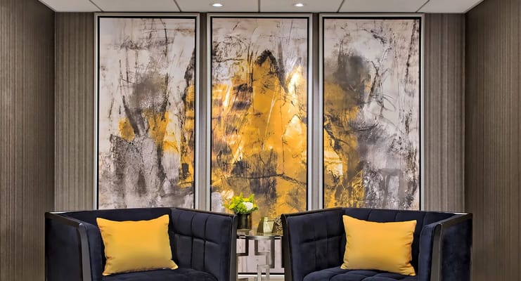 Chic lounge area featuring modern art and yellow-accented furniture.