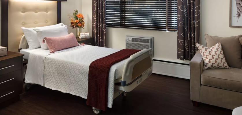 Well-decorated resident room with bed and seating area