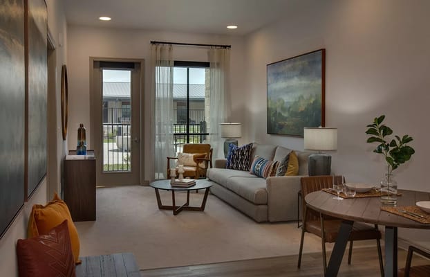 Inviting living room with a sofa, coffee table, and dining area