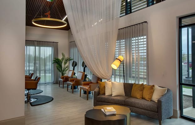 Cozy living room with modern furnishings and large windows.