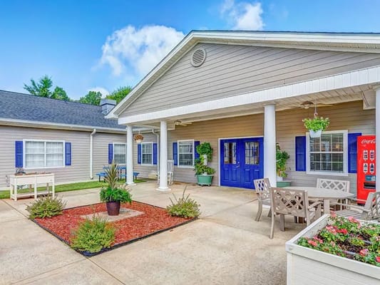 Exterior view of a building entrance with patio seating