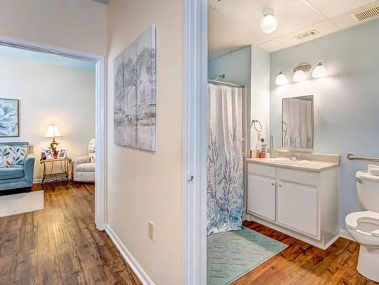 Brightly lit bathroom and sitting area in a resident unit